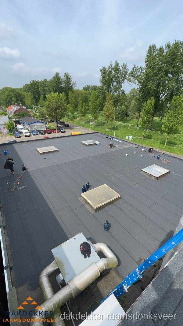Dakdekker aan het werk op groot plat dak met bitumen in Raamsdonksveer Dakdekker aan het werk op groot plat dak met bitumen in Raamsdonksveer